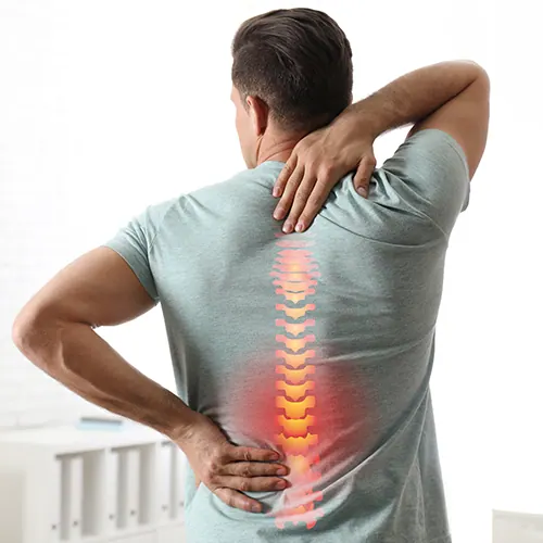 Man holding his lower back with the spine highlighted
