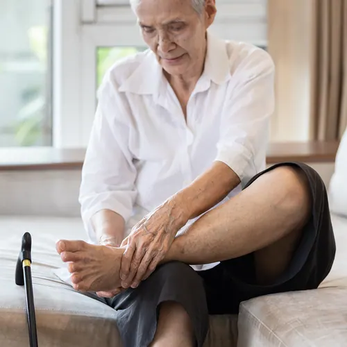 Senior woman rubbing her foot