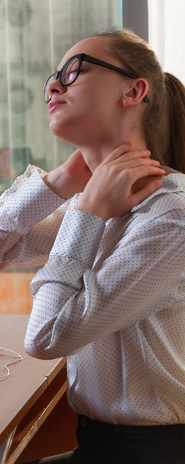 Woman with neck pain at her desk